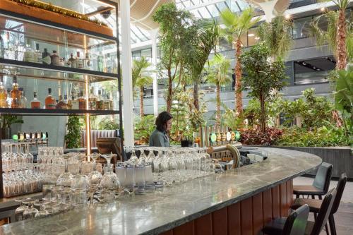 a bar in a restaurant with glasses on a counter at Crowne Plaza Copenhagen Towers by IHG in Copenhagen
