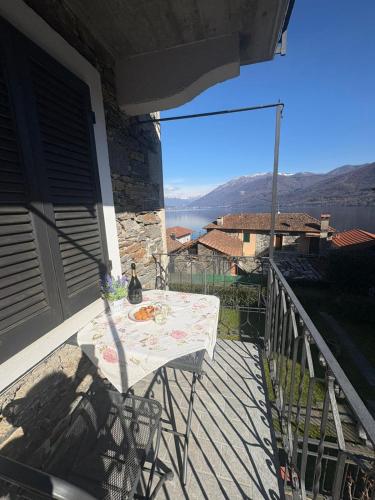 a table on a balcony with a view of the water at Casa Aurelia in Pella