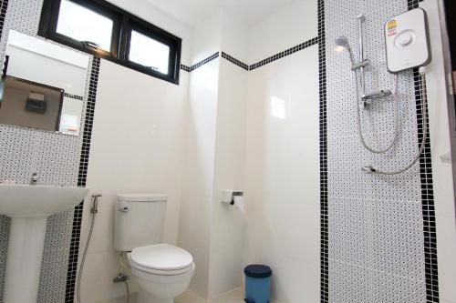 a bathroom with a toilet and a sink and a shower at Old City Boutique House in Sukhothai