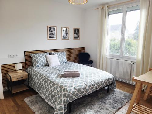a bedroom with a bed and a window at Ernest Lodge Angers in Angers