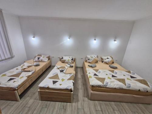 a room with three beds in a room at Konak Kod Gorana 1 in Subotica