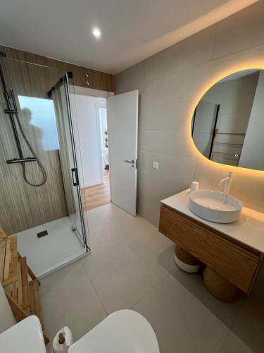 a bathroom with a sink and a shower at RÍA LIVING - Calma 02 in Cee