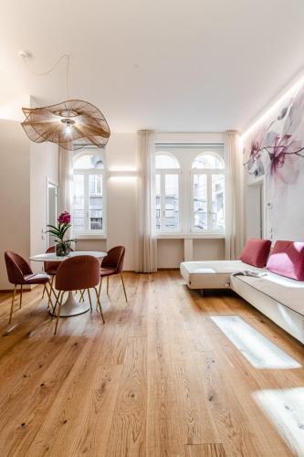 a living room with a bed and a table and chairs at Realkasa Kairos Luxury Apartments in Bologna