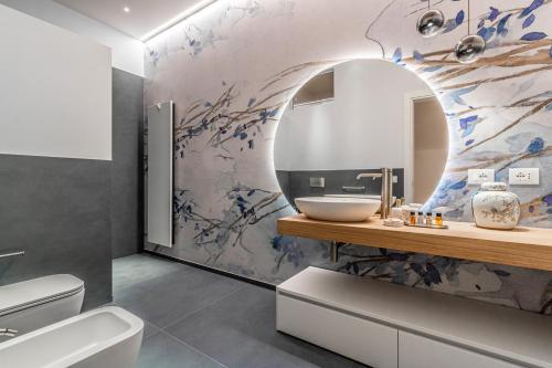 a bathroom with a sink and a mirror at Realkasa Kairos Luxury Apartments in Bologna