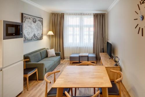 a living room with a couch and a table at Louren Apartments in Prague