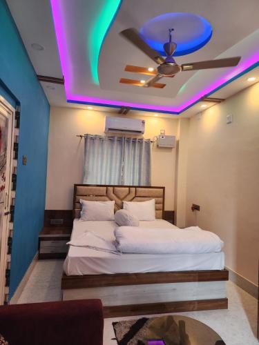 a bedroom with a bed with a purple ceiling at Paromita inn in Tajpur