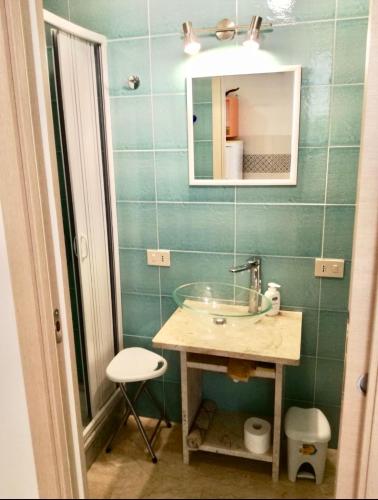 a bathroom with a sink and a mirror at Studio Osnao Historic City Center in Cefalù