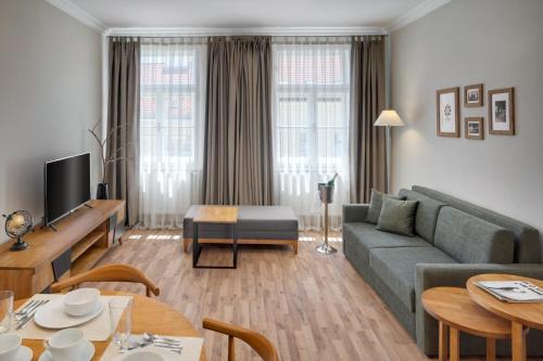 a living room with a couch and a table at Louren Apartments in Prague