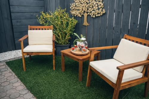 two chairs and a coffee table on a patio at Boutique Guest Suite Private Entrance Near Hard Rock FLL Airport Cruise Port in Fort Lauderdale
