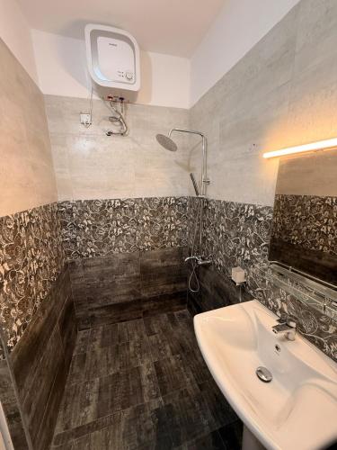 a bathroom with a sink and a shower at 2BR luxury Apartment in Mount Lavinia - Benetia Stay in Mount Lavinia