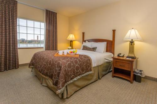 a hotel room with a bed and a window at Staybridge Suites Great Falls by IHG in Great Falls