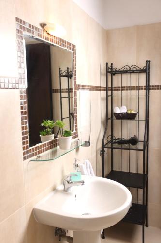 a bathroom with a sink and a mirror at MaGia Peristeridi in Polychrono