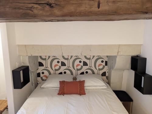 a bedroom with a bed with a headboard at La Maison BellecOur in Vaudelnay