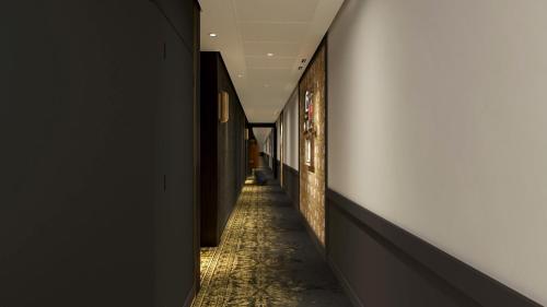 a corridor of a hallway with a long hallway at Hotel Indigo Paris - Opera by IHG in Paris