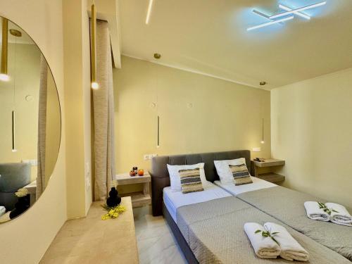 a bedroom with two beds and a mirror at Villa Sunray Sidari with private pool by DadoVillas in Sidari