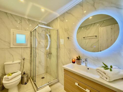a bathroom with a shower and a toilet and a sink at Villa Sunray Sidari with private pool by DadoVillas in Sidari