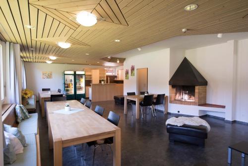 a living room with a table and a fireplace at juhui Lenzerheide in Lenzerheide