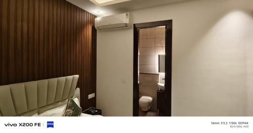 a hotel room with a bed and a mirror at Hotel Velina in Dhāmpur