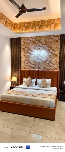 a bedroom with a bed with a stone wall at Hotel Velina in Dhāmpur