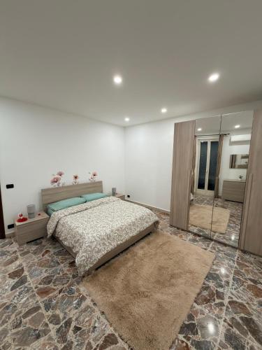 a bedroom with a bed and a large mirror at La casa di Nerone in Acireale