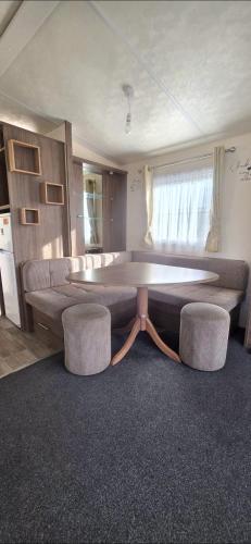 a living room with a large table and two chairs at BILOT Caravan in Heysham