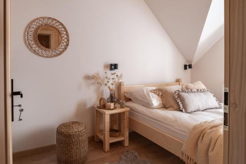 a bedroom with a bed and a mirror on the wall at Skalne Wzgórze in Ochotnica Dolna
