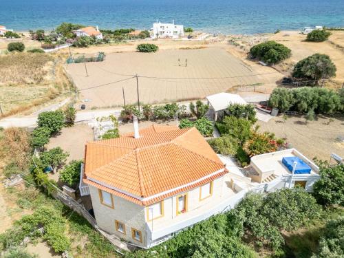 an aerial view of a house with a tennis court at Ocean Melody in Megás Limniónas