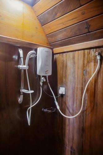 a hair dryer is attached to the wall of a room at Orelia villas in Badulla
