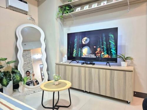 a living room with a large flat screen tv at STUDIO TYPE CEBU CITy in Cebu City