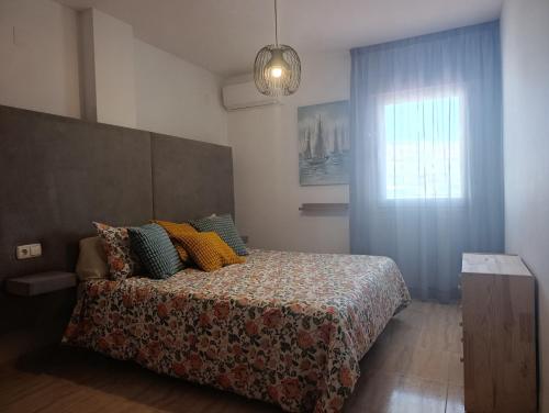 a bedroom with a bed and a window at ALMERIMAR GOLF AND PoOL APARTMENT in Almerimar