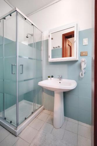 a bathroom with a sink and a glass shower at Santa Caterina 3 - San Bernardo in Crema