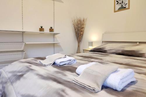 a bedroom with a bed with towels on it at Santa Caterina 3 - San Bernardo in Crema