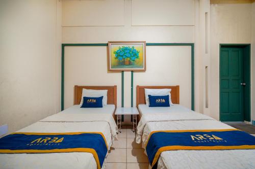two beds sitting next to each other in a room at Griya Astoeti By ARBA in Kopo 2