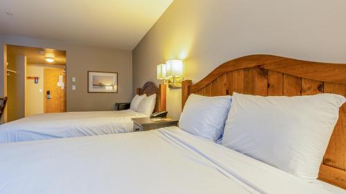 a hotel room with two beds with white pillows at Cahilty #225 home in Sun Peaks