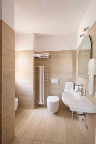 a bathroom with a white toilet and a sink at Hotel Fiamma & SPA Cesenatico in Cesenatico
