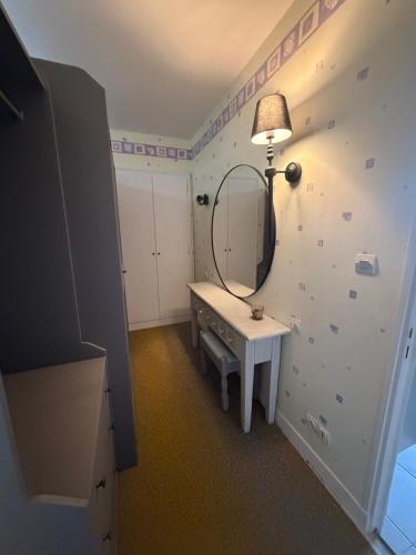 a dressing room with a mirror and a dressing table at Bed & Breakfast Chateau Saintonge in Le Chevain