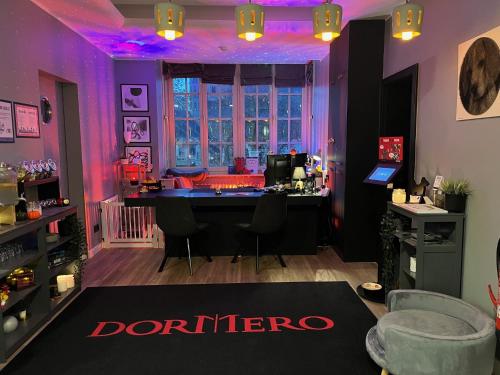 a salon with purple lighting and a table in a room at DORMERO Hotel Xanten in Xanten