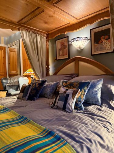 a bedroom with a large bed with a wooden headboard at Clachan Garden B&B in Garve