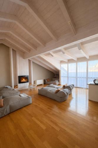 a large room with two beds and a fireplace at Hotel Fiamma & SPA Cesenatico in Cesenatico