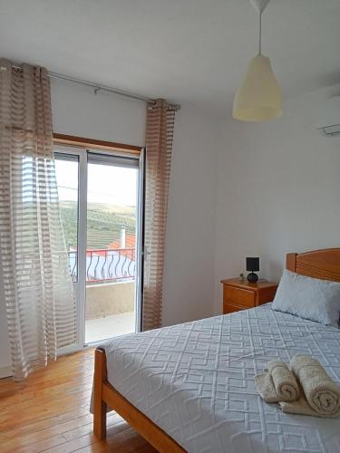 a bedroom with a bed with two towels on it at Casa da Eira - Alojamento Local in São João da Pesqueira