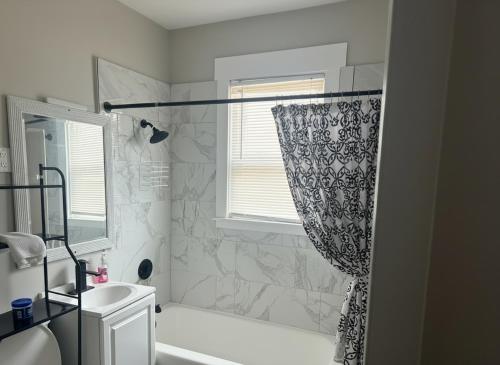 a bathroom with a shower curtain and a sink at City Retreat in Chicago