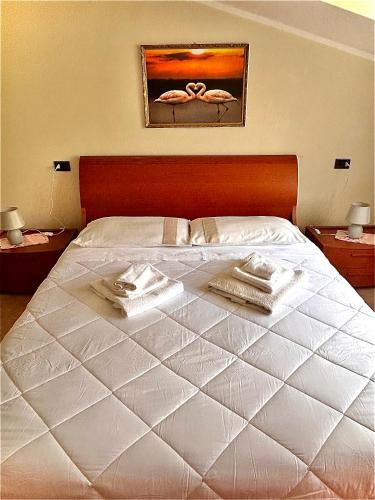a bedroom with a bed with towels on it at La Fabiola in Langhirano