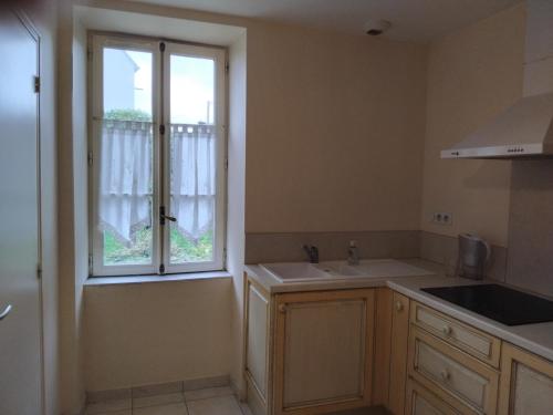 a kitchen with a sink and a window at Roz Aon in Châteauneuf-du-Faou