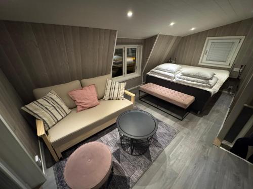 an aerial view of a room with a couch and a bed at TinyHouze in Karlskrona