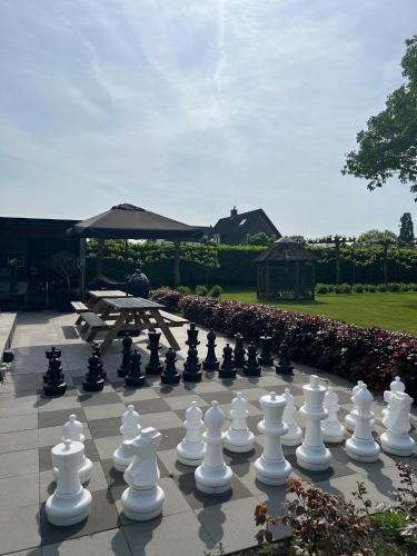 a large chessboard on a patio with a table at Bed and Breakfast Roodkapje in Kaatsheuvel