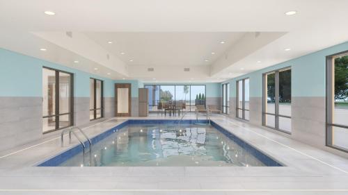 a swimming pool in a house with windows at Holiday Inn Express & Suites Oklahoma City Northwest by IHG in Oklahoma City