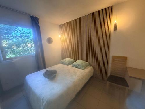 a small bedroom with a bed with a window at Le Clos d'Aix studio 102 in Aix-en-Provence
