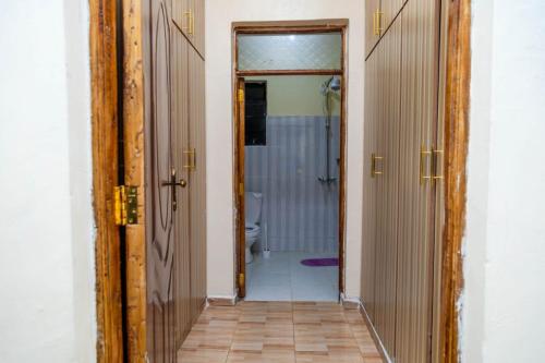 a bathroom with a shower and a toilet in a room at Legacy by Fralec in Nyeri