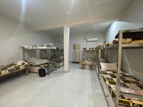 a large room with bunk beds in a room at Giri Ashraya in Govardhan