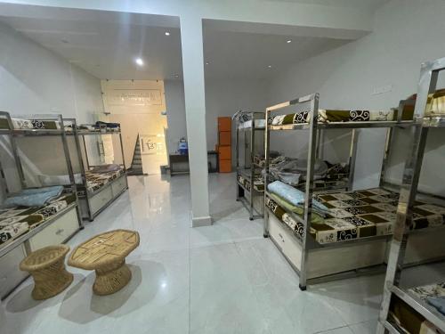 a room with tables and stools in a store at Giri Ashraya in Govardhan